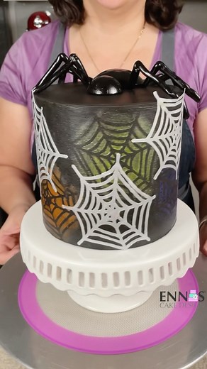 3.7K views · 1.2K reactions | This cake it’s perfect for a Halloween celebration. The cake is covered in black ganache, decorated with icing sheet spiderwebs and stencils made with the cricut machine, topped with a super easy to make isomalt spider. Do you think it’s too early for Halloween content? - Icing sheet @icingimages - isomalt @simicakes1 - explore air 2 @cricut - edible glaze @pmecake - acrylic disk and scraper @cakesafe | Ennas' Cake Design | Facebook