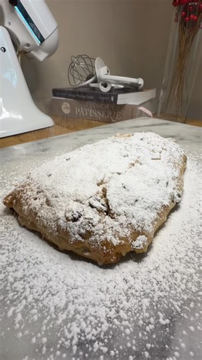 La Panetière | Viennoiseries & Pâtisseries on Instagram: "Diving into holiday baking with this homemade Stollen! 🍞✨ Originating from Dresden, Germany in the 1400s, it started as a simple Advent fasting bread (no butter or milk allowed). But in 1491, Pope Innocent VIII granted a “Butter Letter” dispensation, turning it into the rich, fruit-filled delight we know today—shaped like baby Jesus in swaddling clothes and dusted with snowy powdered sugar. #Stollen #ChristmasBaking #HolidayTraditions"