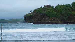 A hidden beach that is still very empty of tourists in Pacitan district, East Java province, Indonesia, which has white sand and charming waves. The beach with a very beautiful view in the morning