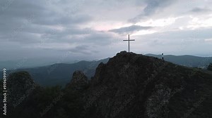 Caucasian woman walk downhill hill visit cross uphill by famous Azeula fortress.Sightseeing popular destination in Georgia. Scenic caucasus mountains panorama
