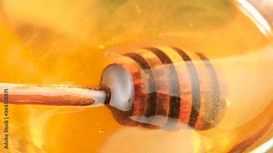 Use a honey stick to slowly mix the honey in the jar.