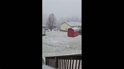 Heavy snowfall accumulates during cold afternoon in Harlan, Kentucky, USA