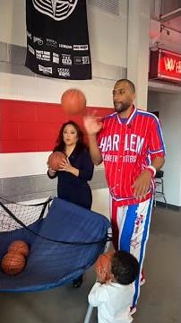 Angela An plays pop-a-shot with Harlem Globe Trotter