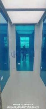 The stainless steel mirror-etched passenger elevator, paired with off-white flooring