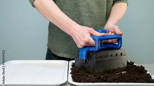 Using soil blocker to create soil blocks. Soil blocking is an ingenious, economical, and ecofriendly seed-starting method. Soil blocking. Stock Video