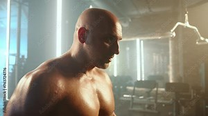 A man is engaged in a simultaneous bicep workout, confidently performing curls with two dumbbells, targeting arm strength and symmetry in the gym. Camera 8K RAW.