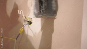 Male builder use metal spatula for putty walls, repairman filling spatula with spackling paste and covering cement wall surface. Builder leveling wall and angle Renovation work in Residential Premises
