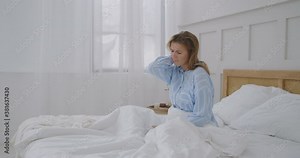 young woman lying in bed in morning feels pain in neck after night sleep, awaken having painful sudden ache or stiffness, incorrect posture during sleep. Fibromyalgia concept