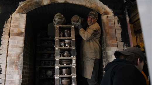 Firing a wood-fired kiln is a group effort, requiring constant tending, feeding of wood and spreading of coals to maintain the right temperature to turn clay into ceramic. By the time David Swenson, associate professor of ceramics and sculpture at North Dakota State University, pushed open the door of the Renaissance Hall wood kiln on Wednesday, April 17, days of work had been put into the firing process. The kiln fired from Monday, April 8, to Friday, April 12, under constant watch by faculty, 