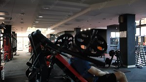 February 21, 2023 Ukraine, Dnipro. strong bodybuilder, sporty fitness man pumping up arm muscles bodybuilding training, background concept - muscular handsome men doing fitness exercises in the gym