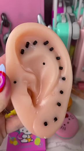 Demonstrating Piercing Techniques on Silicone Ear Model