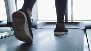 Young Fit Woman Walking on Treadmill in Gym. Cardio Training Weight Loss Concept. 4K Slowmotion Footage.