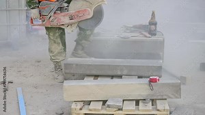 A man is using a chainsaw to cut a concrete block, a versatile tool commonly used in construction for cutting building materials like wood, flooring, and hardwood Stock Video