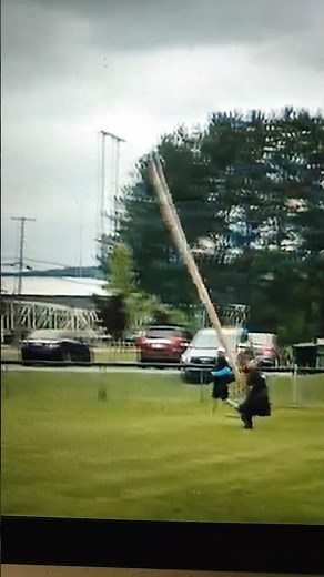 Strong toss of caber toss at Highland games