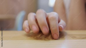 Impatient person tapping on the table with fingers