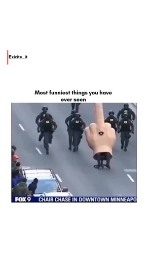 exicite_it on Instagram: "This post shares a 12-second video of a person in a giant, inflatable "middle finger" costume being pursued by police through city streets, titled "Most funniest things you have ever seen." The clip, which captures a surreal moment of urban "chair chasing," has amassed over 250,000 views and significant engagement since being posted 6 months ago. ​The footage captures a unique intersection of performance art and public disruption. From a psychological perspective, such