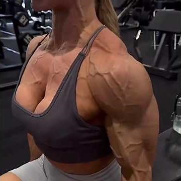 Muscular goddess flexing her biceps and veins exploding
