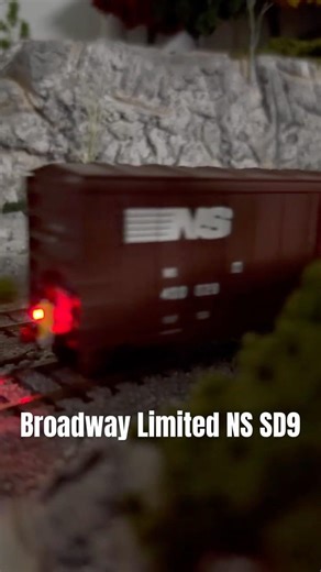 HO Scale Broadway Limited Norfolk Southern SD9 Diesel Locomotive Pulling A Short Freight Train