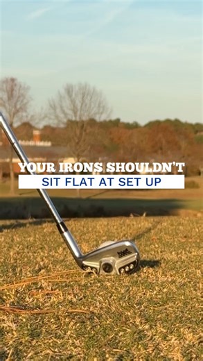Don’t force those irons flat at address for the two reasons discussed above. First, the shaft is going to flex into impact (shaft droop). As this occurs this can angle the toe of the club down. If you force the club flat, then the toe angles down, you’re now going to have the toe of the club enter the ground. But if the clubs sits slightly toe up and then angles down, the club now is flat into impact. Second, I see players compromise their set up and arm position which can create tension and not
