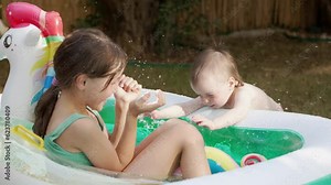 Group of Little Girls of Various Ages Play and Have Fun in a Pool Stock Video