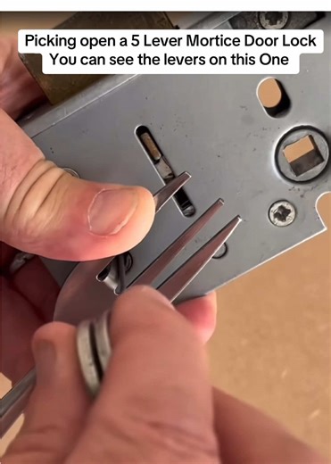 Picking open a 5 Lever Mortice Door Lock using a dinner fork as the tension tool, You can see the levers on this One