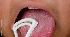 Mouth open and using tongue scrapper