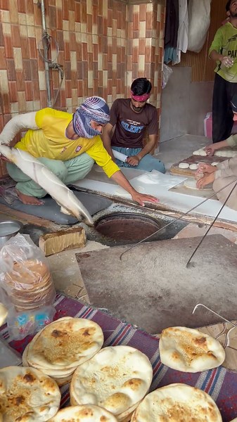 Traditional way of baking bread in a clay oven 😋#bread #clayoven #food #fyp