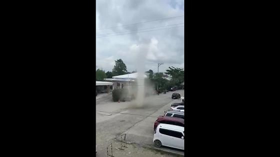 Pupils flee as dust devil tornado twists along street