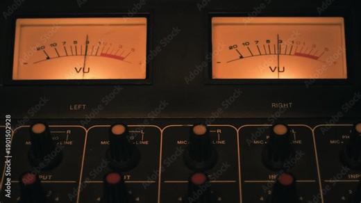 VU meters and mixing channels of an audio console. Symbol of music production, recording studio and live show broadcasting. A pro equipment video loop, with natural colors