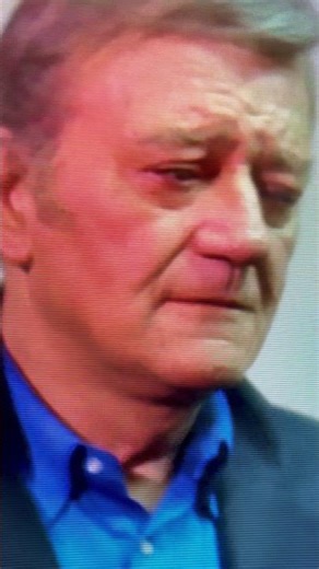 JOHN WAYNE IS CONFRONTED BY A PROTESTER.