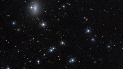 Hubble spots a nearly invisible galaxy in rare image
