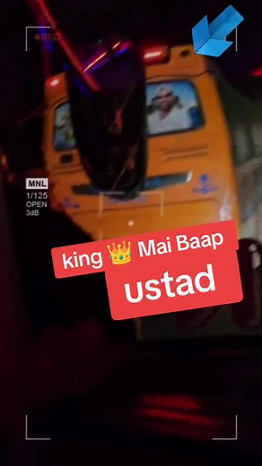 Brightly Lit Orange Bus Driving at Night