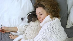Woman Sleeping With Her Dog In Bed On Pillow.