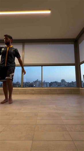 Freestyle football performance indoors at sunset