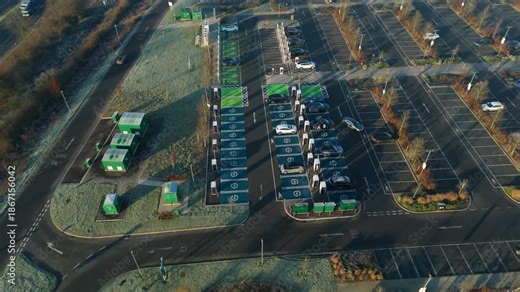 Top down aerial view of EV electrical vehicle charging hubs, modern car technology, no fossil fuels at a service station in the United Kingdom.