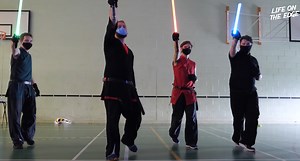 Star Wars fans take part in Lightsaber combat training.