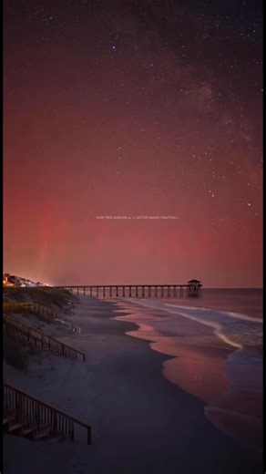 🔥 EXTREMELY RARE SIGHTING! The Outer Banks lit up with a blood-red aurora tonight — something locals may never witness again in their lifetime. This surreal glow was caused by an intense geomagnetic storm pushing auroral activity far into the southern United States. The sky turned bright crimson and magenta, reflecting over the calm water, beaches, and piers of the OBX. If you saw it — you witnessed history. If you missed it — this is what it looked like. 🌌❤️ ⚠️ These moments remind us how pow