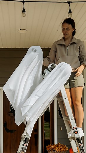 Kendra Clark | Farm & Home DIY on Instagram: "To be clear! We didn’t build it, but bought it shortly after it was finished, and let’s just say… the layout needed some serious help. So while we’re in the middle of moving our staircase and reconfiguring half the house, the kids made it very clear that skipping Halloween décor was not an option. So here’s how I made the easiest hanging porch ghosts—perfect for an overwhelmed (or lazy) DIY mom 👻 1️⃣ Inflate a clear beach ball with the plug facing u