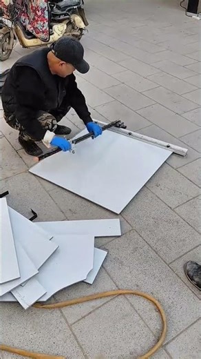 Professional Worker Using Manual Large Format Ceramic Tile Cutter