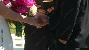 Bride and Groom holding hands on their wedding day during ceremony.