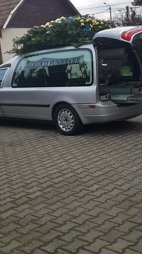 Funeral Procession with Hearse and Floral Casket