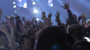 Vigorous and excited music fans dancing at the concert