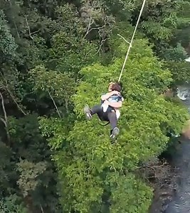 Reckless dad jumps 200ft off bridge in bungee jump stunt while holding toddler daughter (video)