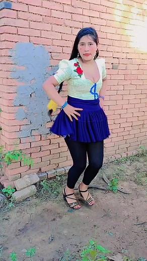 Floral Skirt Twirl Against Brick Wall