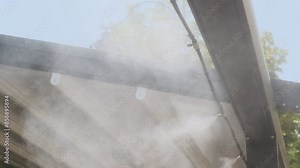 Air conditioning and water spray system for cooling and fog. Fogging system for outdoor cafe terraces. Humidify, cooling and cleaning air from dust in hot day. Air humidification for plants in summer