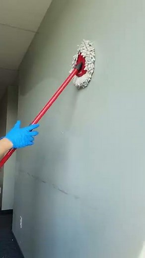Using Vileda Mop to wash walls and baseboard