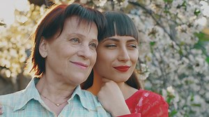 Old mother with her young daughter in a flower garden - Free Stock Video