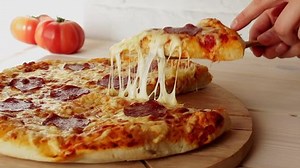 taking slice of pizza with super stretching cheese