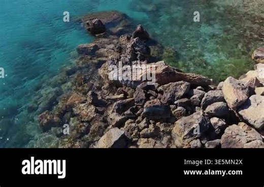 Aerial drone view of a quiet Konnos Beach rocky bay with crystal clear turquoise water in Cyprus Stock Video Footage - Alamy