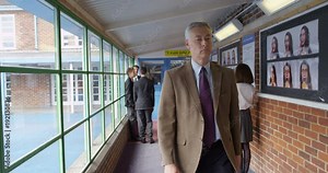 4K Strict teacher in inner city British school disciplining a pupil for scruffy his uniform. Slow motion